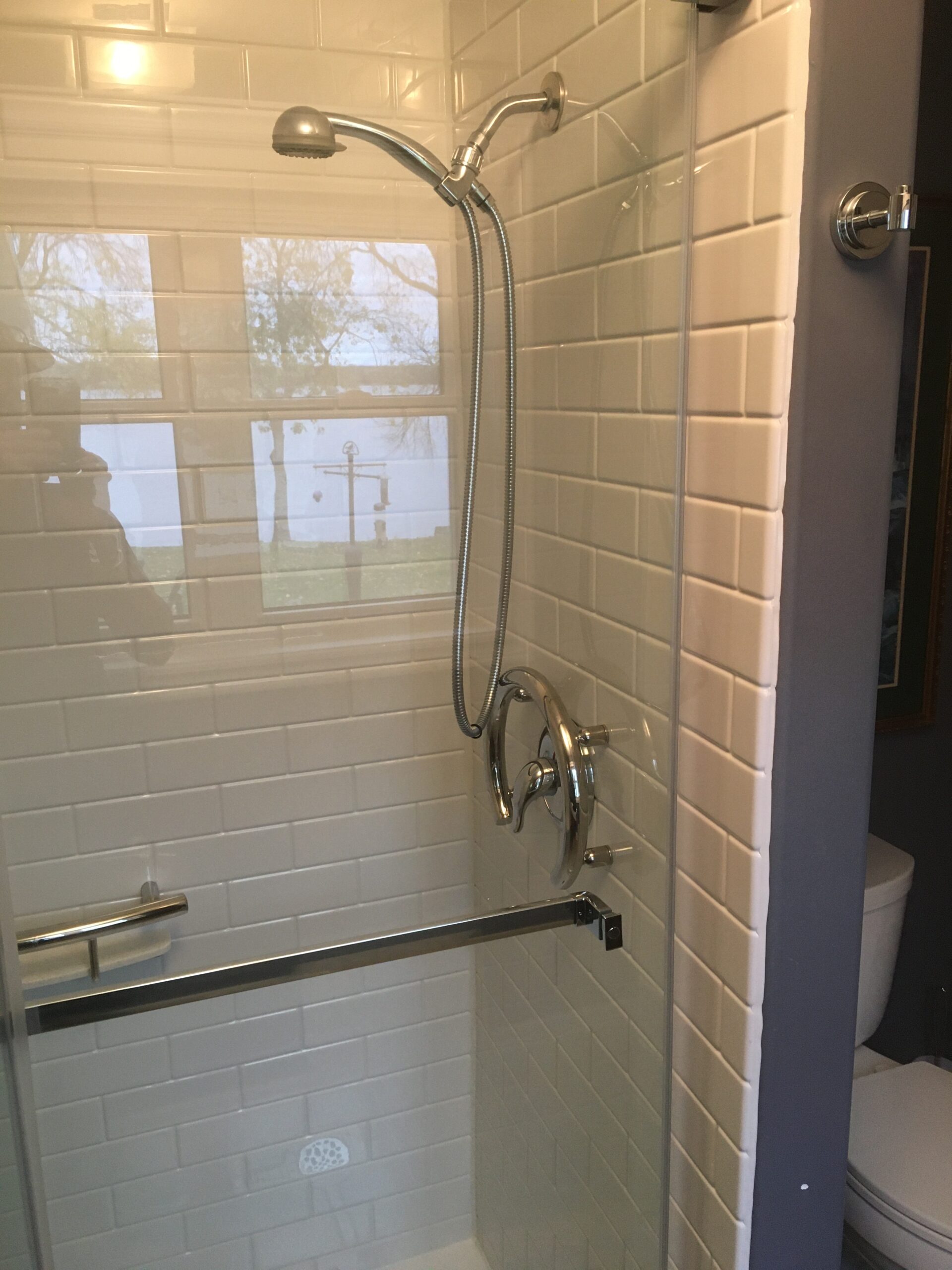 After image of a new acrylic shower with subway tile design and glass doors, highlighting bathroom remodeling and shower installation.