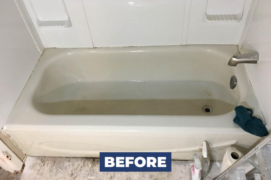 Old greenish bathtub before replacement and bathroom remodeling.