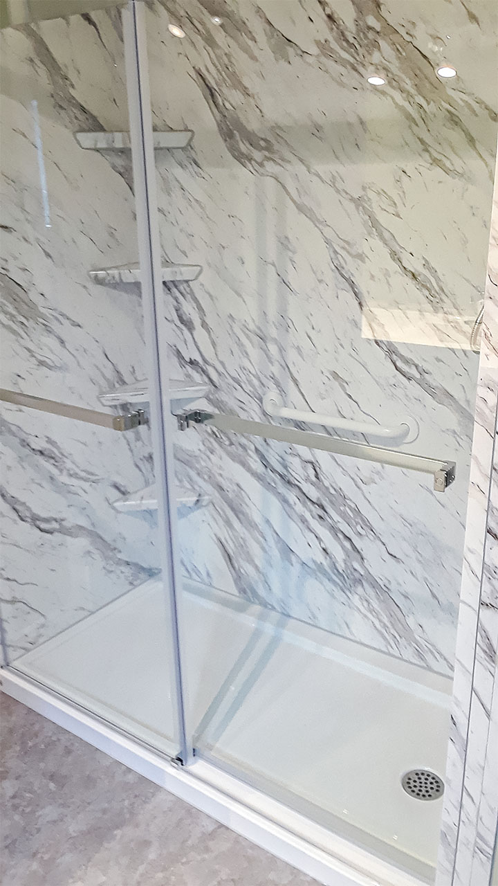 After image of a new acrylic shower with marble-like appearance, showcasing bathroom remodeling and shower installation.