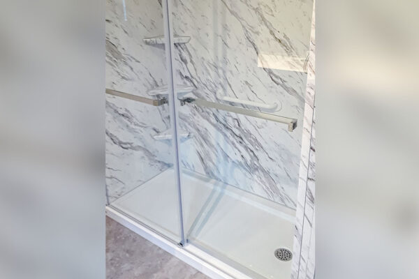 After image of a new acrylic shower with marble-like appearance, showcasing bathroom remodeling and shower installation.