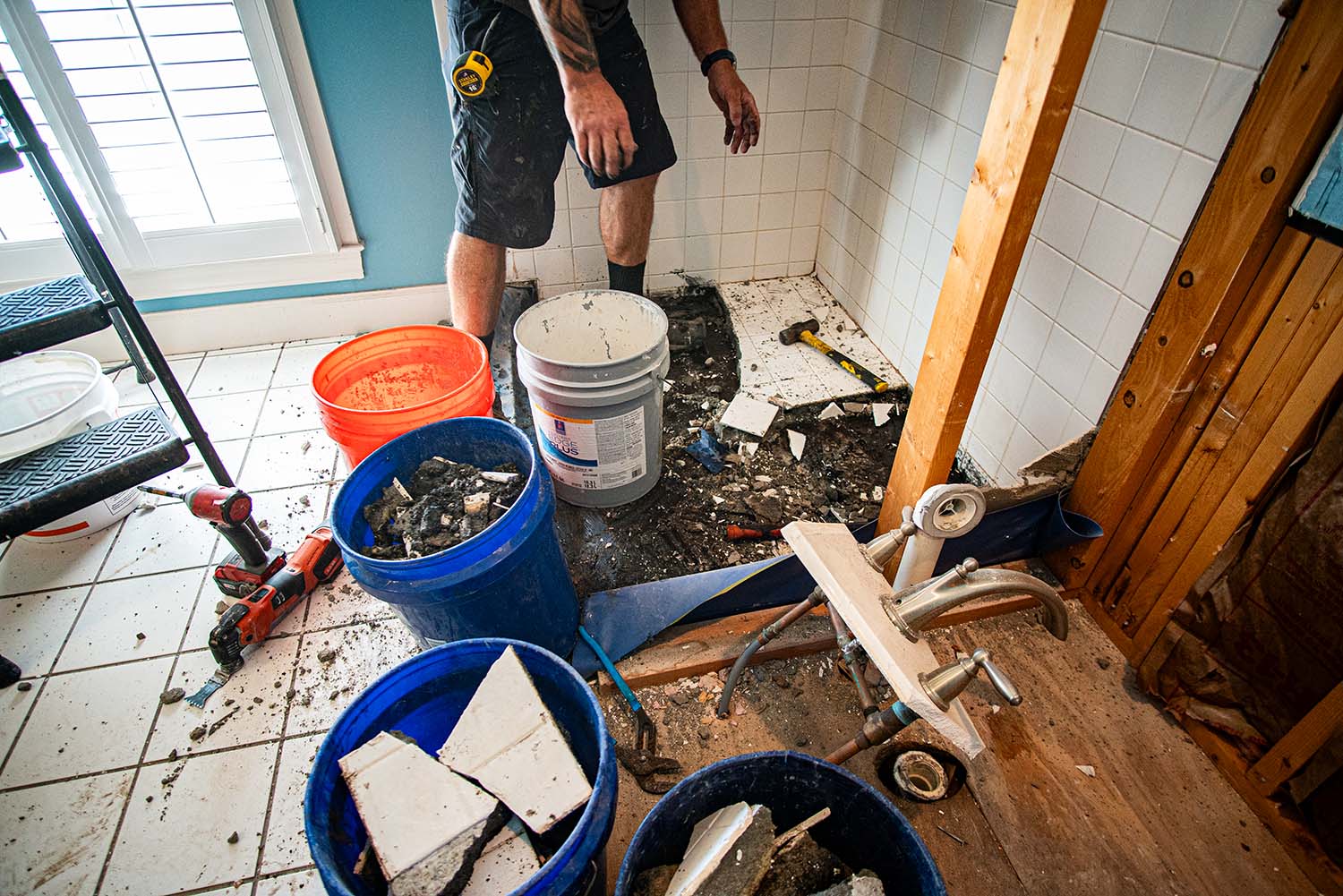 In-progress image showing the grime and mold under the old tile during a shower replacement. (Alternate Angle)