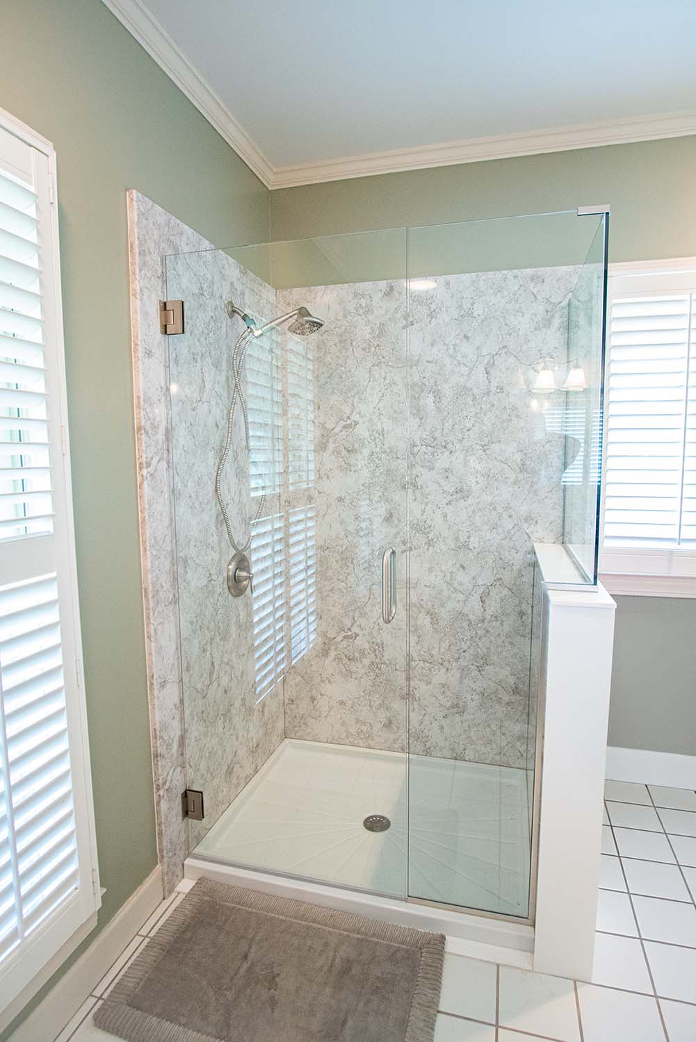 After image of a shower with acrylic walls mimicking granite and an acrylic shower pan, viewed from a different angle.