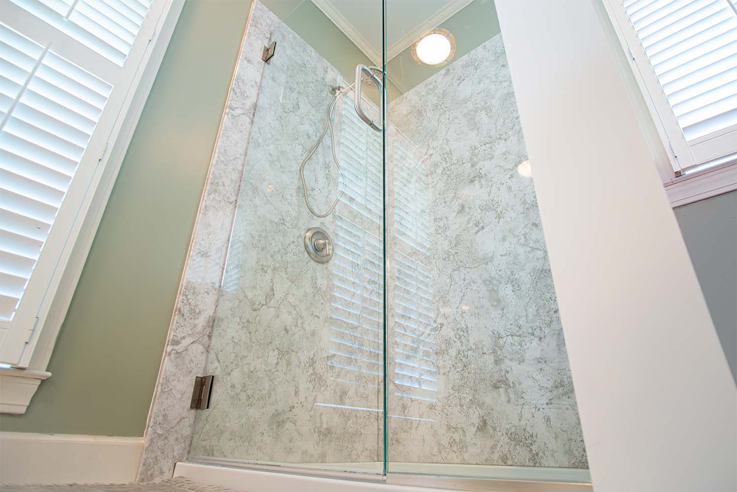 After image of a shower with acrylic walls mimicking granite and an acrylic shower pan.