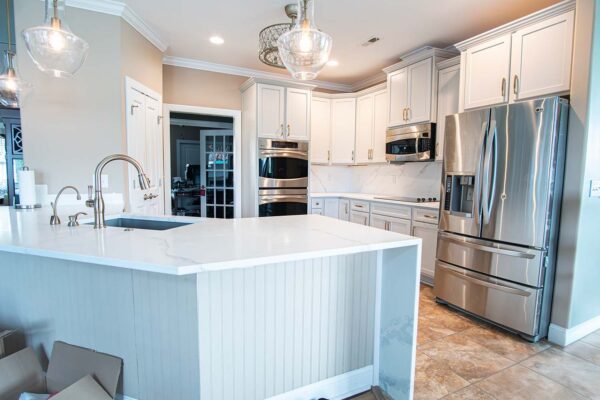 After image of a kitchen showcasing the entire space with autumn style doors in fashion grey and quartz Calcatta Capri countertops