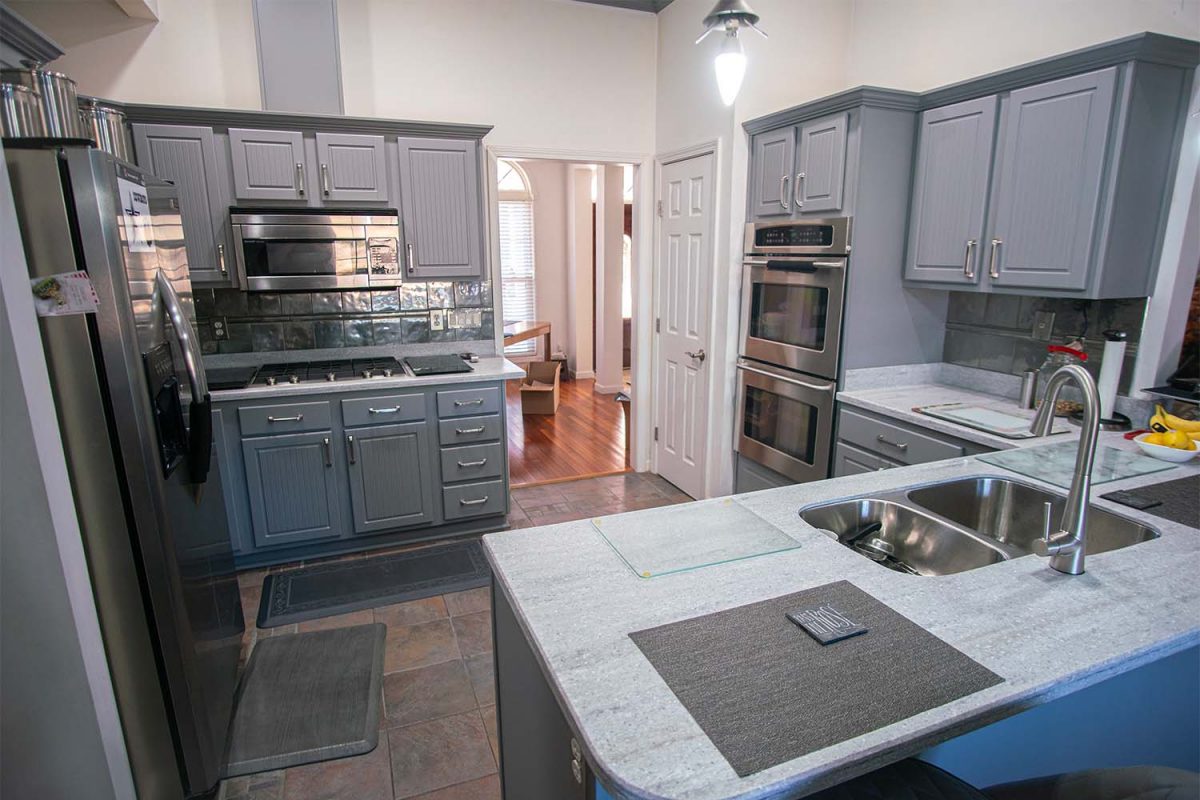 Refaced kitchen with Victory style doors and drawer fronts in dust grey after cabinet refacing.